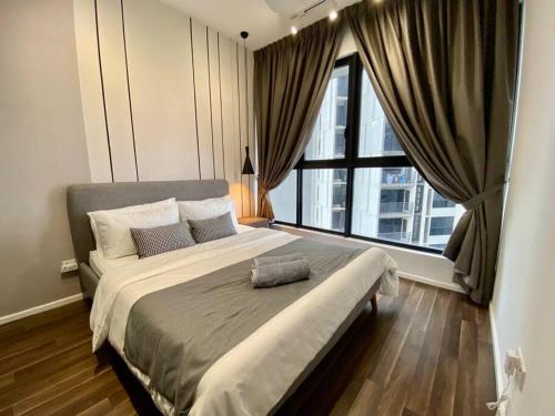 a bedroom with a large bed with a large window at Stylish Nordic Suite, Pool View, 500mbps, GEO Bukit Rimau, Kota Kemuning in Shah Alam