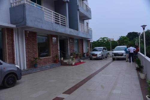 a group of people standing outside of a building at Hotel Girija Sunrise 300 Meter from Baba Dham Temple in Deoghar