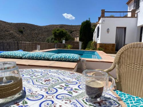 a table with a glass jar on top of a table at A tranquil mountain escape, casa particular, exclusive accommodation, private pool and terraces in Oria