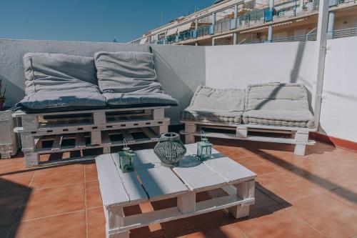 a balcony with two beds and a table on a building at Vivienda Turística Sunbeach-Xilxes VT-42192-CS in Xilxes
