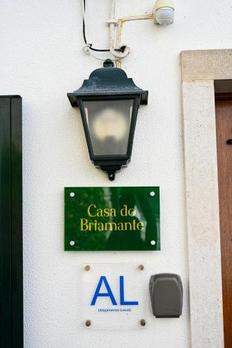 a sign on the side of a building with a street light at Casa do Briamante 9 in Sintra