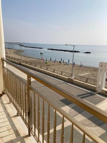 a view of a beach and the ocean from a balcony at IL RICCIO appartamento sul mare in Torre Melissa