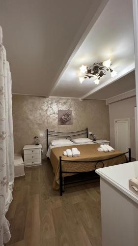 a bedroom with a large bed with towels on it at Martinahouse in Vico nel Lazio