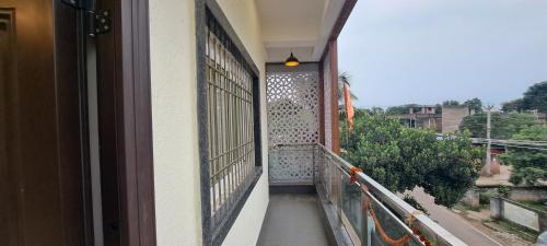 a balcony with a door and a view of a building at The Candy Studio in Rānchī