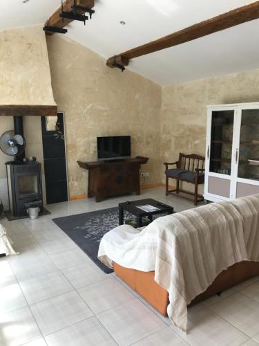 - une chambre avec un lit, une cheminée et une télévision dans l'établissement La Bergerie, à Bourg