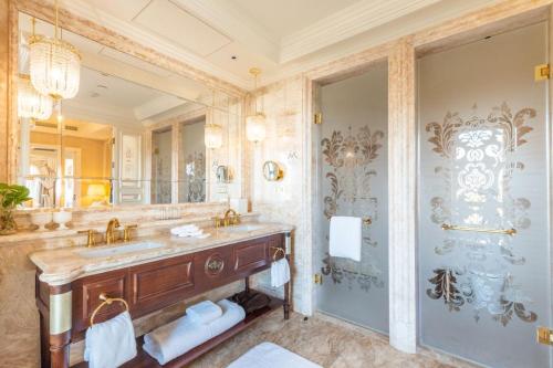 a bathroom with a sink and a large mirror at The Castle Hotel, a Luxury Collection Hotel, Dalian in Dalian