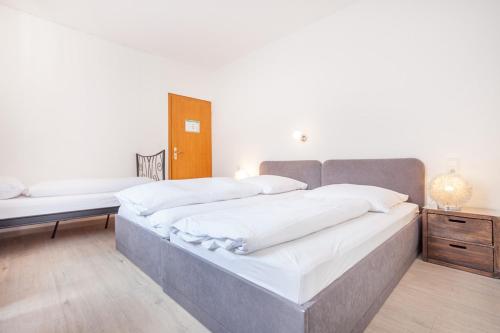 a bedroom with two beds and a night stand at Hotel Union in Dortmund