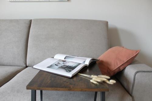 a book on a coffee table on a couch at Bene39 in Turin