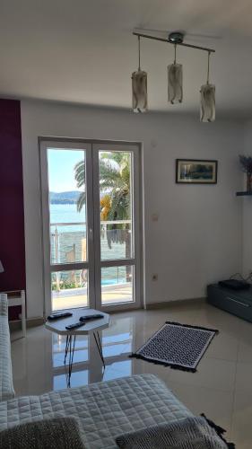 a bedroom with a bed and a view of the ocean at Chic apartment in the City Center by the sea in Tivat