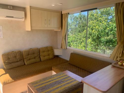 a living room with a couch and a large window at Chalet -O Solar in Arouca