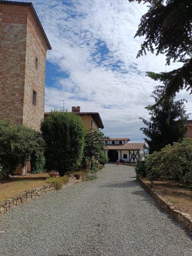 a gravel road in front of a building at Villa Luisa in Ziano Piacentino