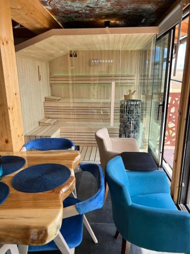 a room with tables and chairs and a sauna at The Crown Lodge in Zlatibor