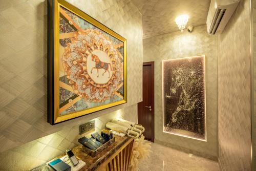 a bathroom with a painting on the wall and a mirror at Ritz Residence, Imago Mall Loft B in Kota Kinabalu
