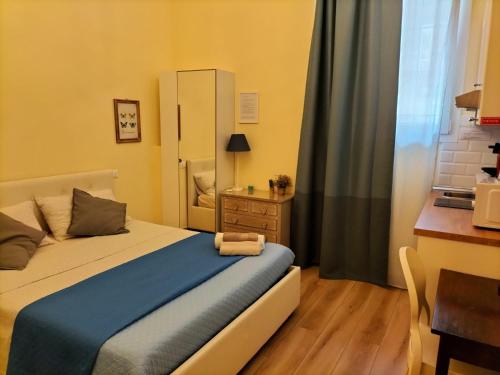 a bedroom with a bed and a desk and a window at BolognaFiera in Bologna