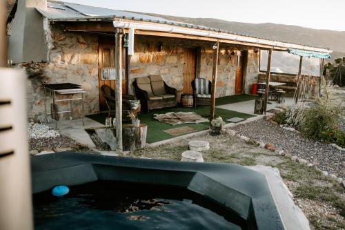 a pool of water in front of a house at Breathe Accommodation in Oudtshoorn