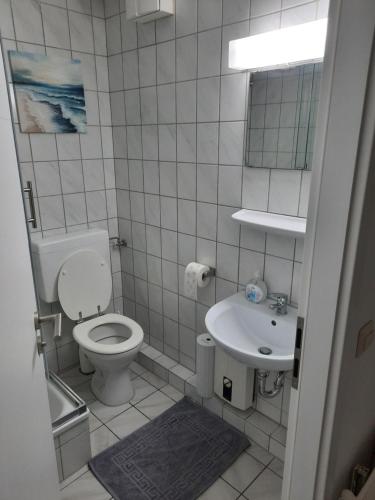 a small bathroom with a toilet and a sink at Apartment in Bielefeld Heepen in Bielefeld