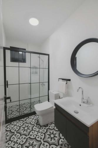a bathroom with a toilet and a sink and a mirror at La Chance Alaçatı in Alaçatı