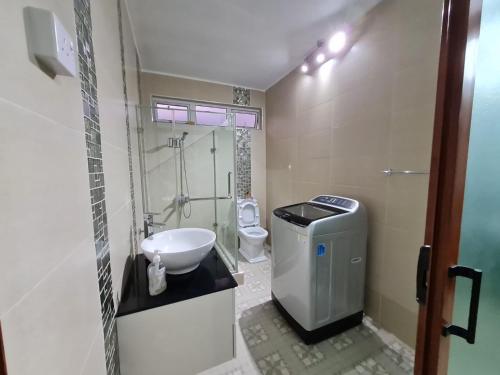 a small bathroom with a toilet and a sink at White Residence in Quatre Bornes