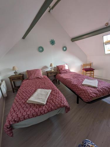 - une chambre avec 2 lits et 2 tables dans l'établissement Appartement pour 2 personnes, à Annequin