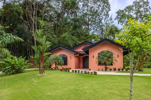 a house with a lawn in front of it at The Garden Villas by Vista Celestial in Uvita