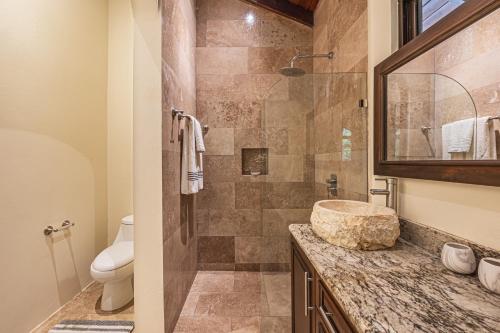 a bathroom with a sink and a toilet at The Garden Villas by Vista Celestial in Uvita
