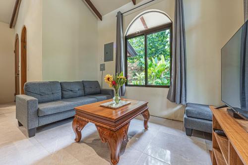 a living room with a couch and a table at The Garden Villas by Vista Celestial in Uvita