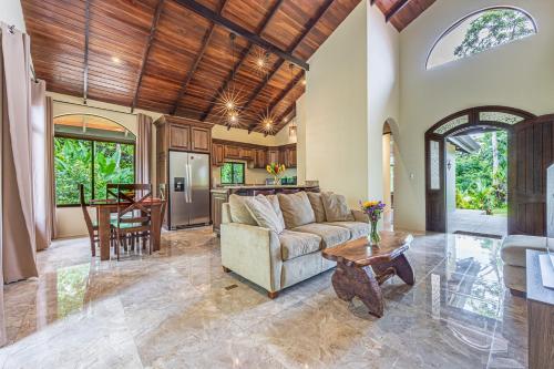 a living room with a couch and a table at Las Palomas Villas Of Uvita in Uvita