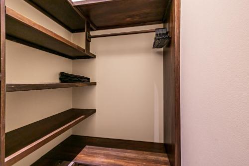 a walk in closet with wooden shelves in a room at The Garden Villas by Vista Celestial in Uvita