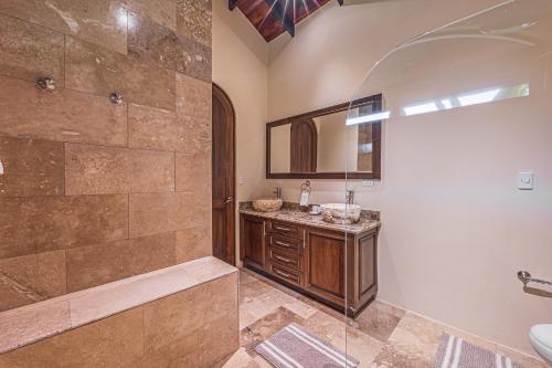 a bathroom with a shower and a sink at The Garden Villas by Vista Celestial in Uvita
