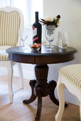 a table with a bottle of wine and two glasses at Studio Apartments Sonatina in Dubrovnik
