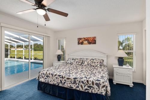 a bedroom with a bed and a ceiling fan at Triple En-Suite Pool Retreat - All Master Bedrooms in Inverness