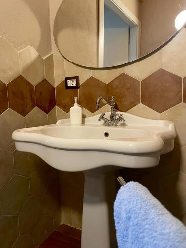 a bathroom with a white sink and a mirror at La Casina di Venere in Savoca