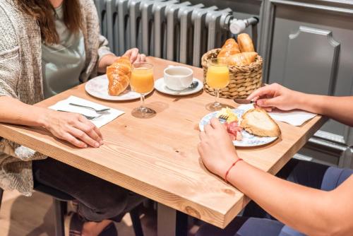 a group of people sitting at a table with food and drinks at Riu Nere Mountain Hotel in Vielha