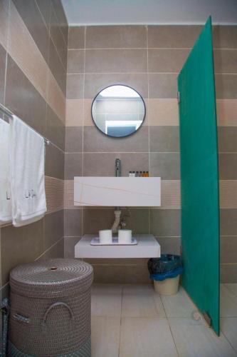 a bathroom with a sink and a mirror at LAVIDA in Abidjan