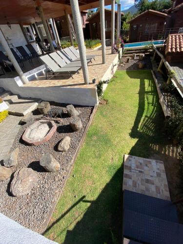 a backyard with a rock garden with a pool at Cabañas Tr'eje in Valle de Bravo