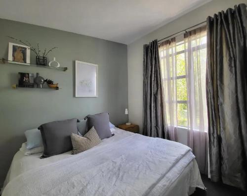 a bedroom with a large bed with a window at Artist Photographers Home Studio in Auckland