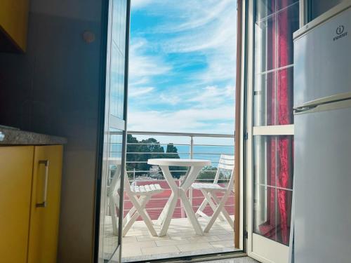 a balcony with a table and a view of the ocean at Stars Home in Tropea