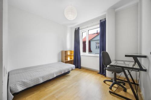 a bedroom with a bed and a desk and a window at Vilmsi 41 Apartment in Tallinn