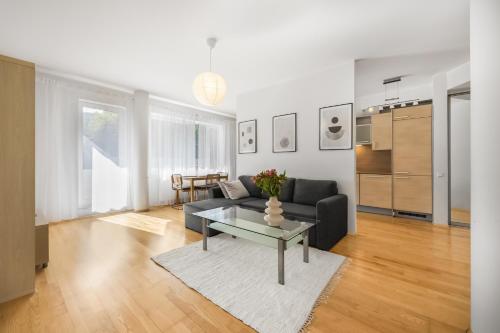 a living room with a couch and a table at Vilmsi 41 Apartment in Tallinn