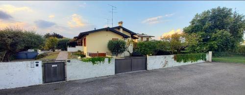 a house with a fence in front of a driveway at VILLA AMA in Pordenone