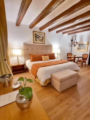 a bedroom with a large bed and a table at Antara Hotel & Suites - Miraflores in Lima