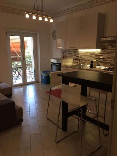a kitchen with a table and chairs in a room at Royal Apartment in Ciampino