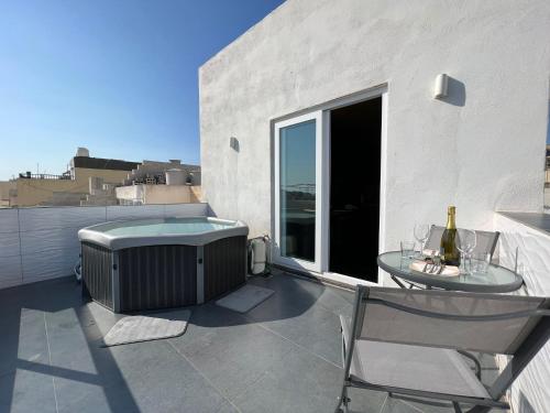 a patio with a heater and a table and chairs at Luxury Penthouse in Sliema in Sliema