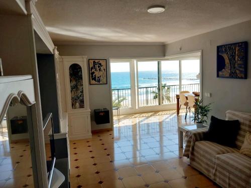 a living room with a view of the ocean at FirstLine BeachView in El Campello