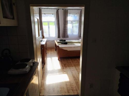 a room with a bedroom with a bed and a window at Vejminek Malý Statek in Slavče