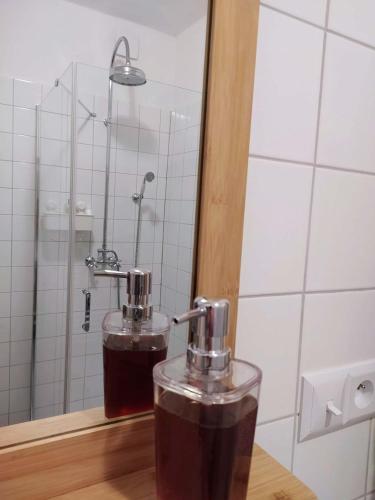 a drink in a glass on a table in a bathroom at Vejminek Malý Statek in Slavče