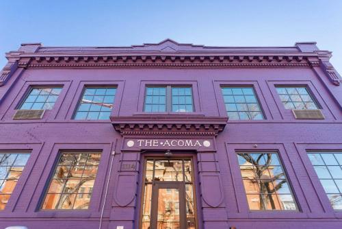 a purple building with a sign that reads the acropolis at The Acoma House in Denver