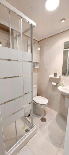 a bathroom with a toilet and a sink at FirstLine BeachView in El Campello