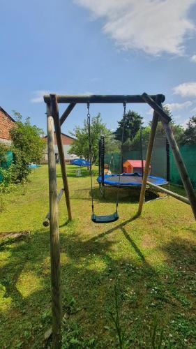 a swing set in a park with a playground at Retrohaus in Liptovský Mikuláš