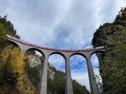 a bridge with a train on top of it at Mountain View Studio Klosters in Klosters